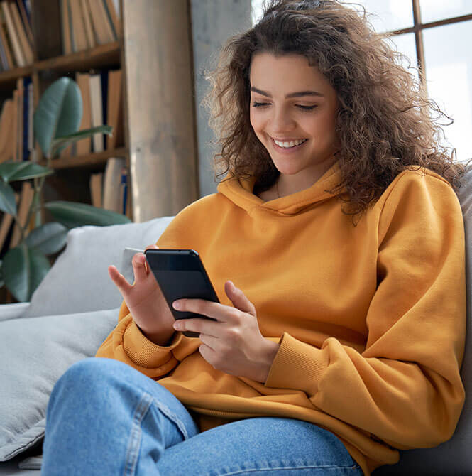 woman on couch banking on a phone